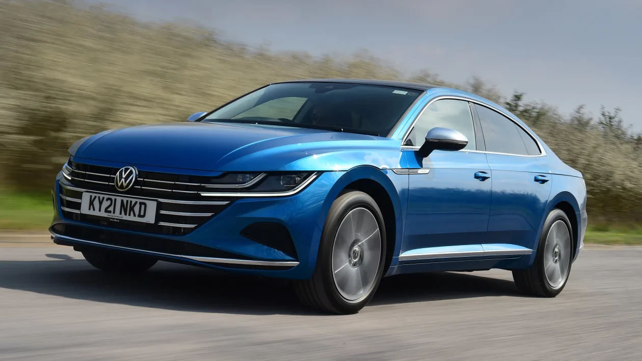 Blue Volkswagen Arteon driving along in countryside