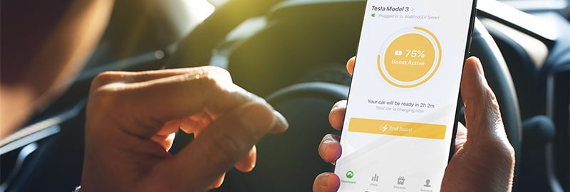 man holding mobile showing app for ev charging