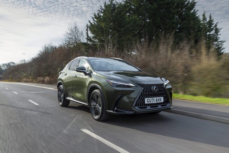 Green Lexus NX 450 PHEV driving on forest road