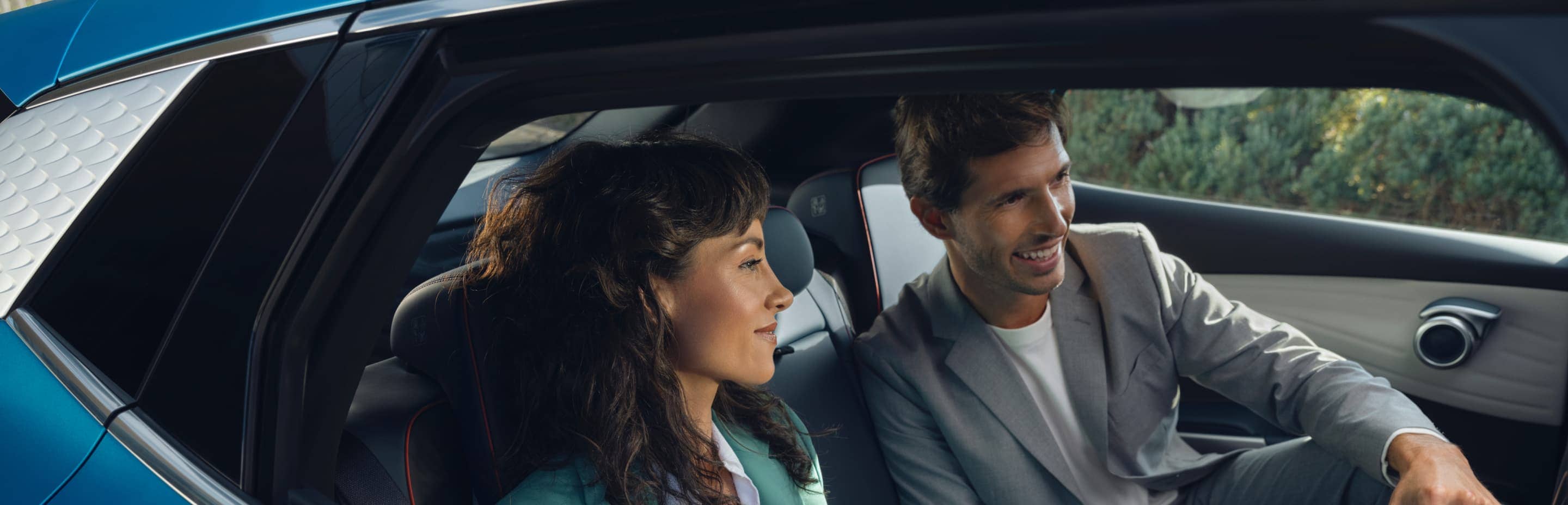 man and women sitting in electric vehicle