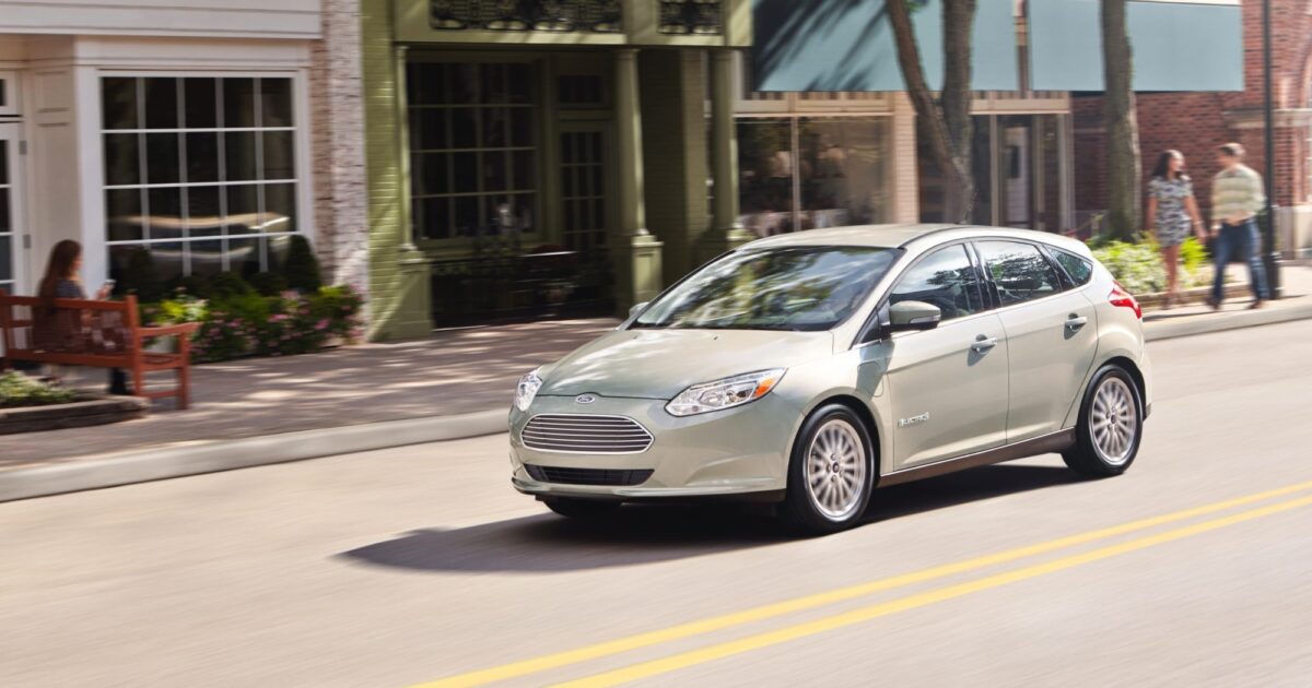 Grey Ford Focus electric driving in city
